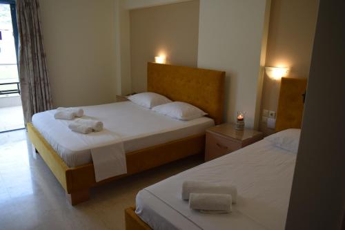 a bedroom with two beds with towels on them at Ammos & Thalassa in Vasiliki