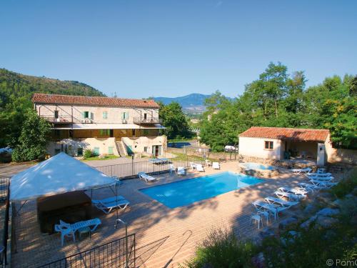 a house with a swimming pool in front of a house at La Maison du Chassezac in Les Assions