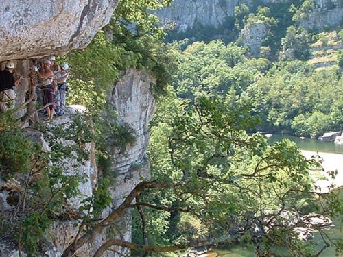 a group of people standing on the side of a mountain at La Maison du Chassezac in Les Assions