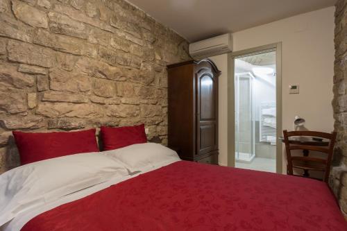 En eller flere senge i et værelse på Hotel Il Duomo
