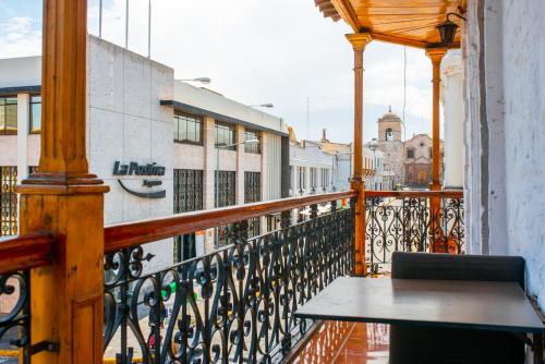 a balcony with a table and a view of a city at Le Foyer Arequipa in Arequipa