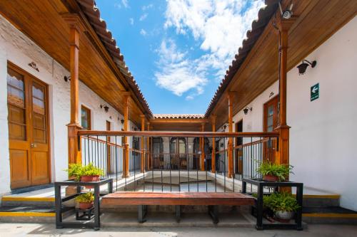 a balcony of a building with a bench on it at Le Foyer Arequipa in Arequipa