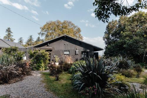 a barn with a garden in front of it at The Croft in Hilton