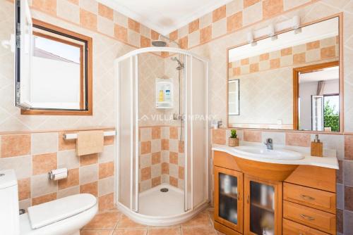 a bathroom with a shower and a toilet and a sink at Villa BELLAVISTA in Arenal d'en Castell