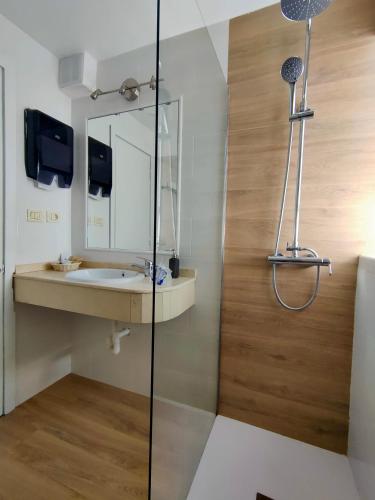 a bathroom with a sink and a mirror at Apartamentos El Paseo in Playa del Ingles