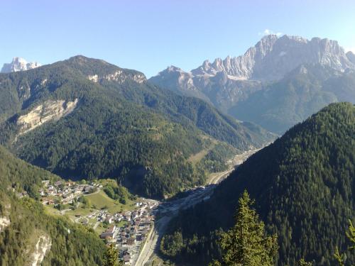 a view of a valley in the mountains with a town at Casa NeveXenne & La Casa di Blek in Alleghe