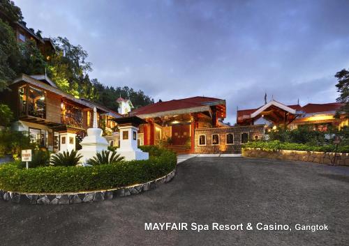a large house with a driveway in front of it at Mayfair Spa Resort & Casino in Gangtok