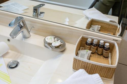 a bathroom counter with a sink and a mirror at Pension Carmen`s Mansion A in Sinaia