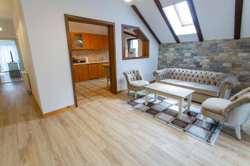 a living room with a couch and chairs and a table at Pension Carmen`s Mansion A in Sinaia