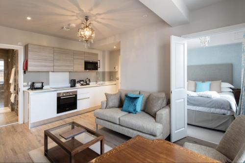 a living room with a couch and a bed at Beech House - Urban Apartments in Bristol