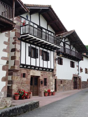 a building with a balcony on the side of it at Pedroenea Apartamento Elizondo in Elizondo