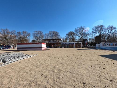 a large empty field with a building in the background at Gosztonyi Villa in Siófok
