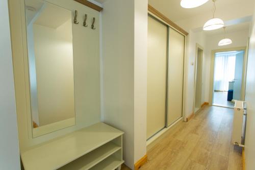 a dressing room with white walls and a mirror at Pension Carmen`s Mansion A in Sinaia