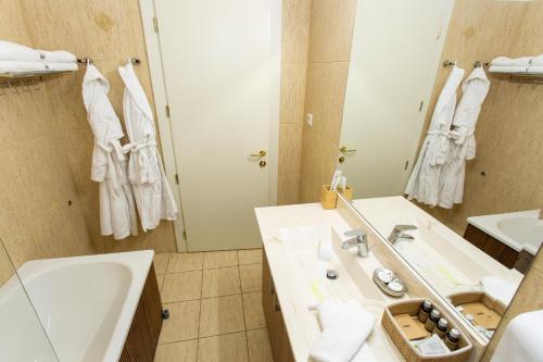 a bathroom with a sink and a mirror at Pension Carmen`s Mansion A in Sinaia