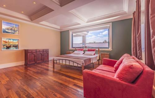 a living room with a red couch and a window at Exclusive VILLA Volme in Banjole