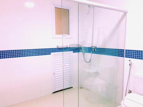 a bathroom with a glass shower and a toilet at Hotel Amália in Sao Paulo