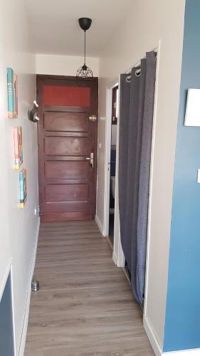 a hallway with a wooden door and a hallway with at JOLI STUDIO 50M DE LA MER in Valras-Plage