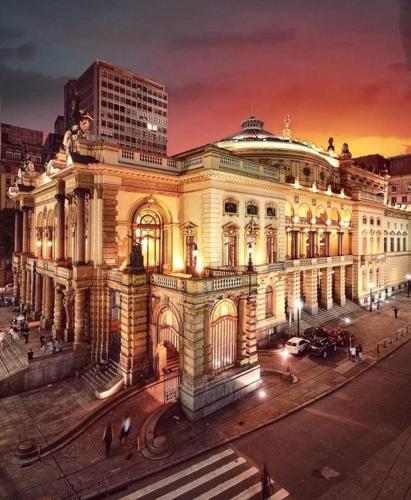 a large building in a city at night at Hotel Amália in Sao Paulo