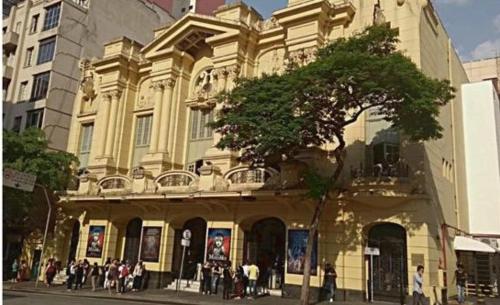 a large building with people standing in front of it at Hotel Amália in Sao Paulo