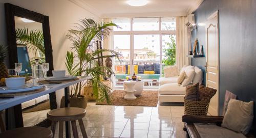 ein Wohnzimmer mit einem Sofa und einem Spiegel in der Unterkunft Un cocon en plein centre ville! En Caze LONDON in Libreville