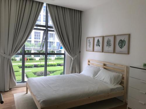 a bedroom with a bed and a large window at Cyberjaya amazing view Fully furnished 3 bedroom in Cyberjaya