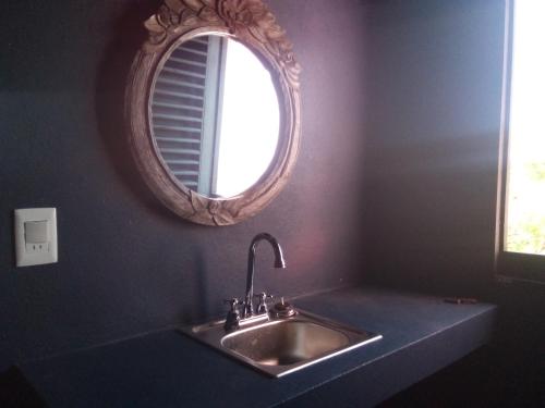 a bathroom with a sink and a mirror at Casa Camilla in Las Galeras