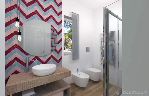 a bathroom with two sinks and a mirror at Appartamento Nonna Lina in Custonaci
