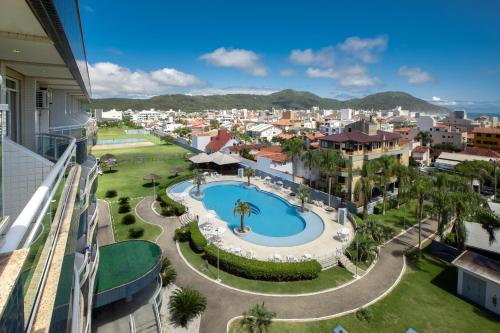 an aerial view of a city with a swimming pool at Oceania Park Hotel Spa & Convention in Florianópolis