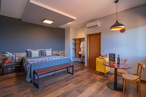 a bedroom with a bed and a table in a room at Cassorova Resort e Ecoturismo in Brotas