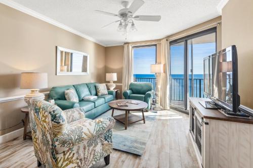 a living room with a couch and a tv at Phoenix X Unit 1211 in Orange Beach