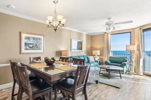 a dining room and living room with a table and chairs at Phoenix X Unit 1211 in Orange Beach