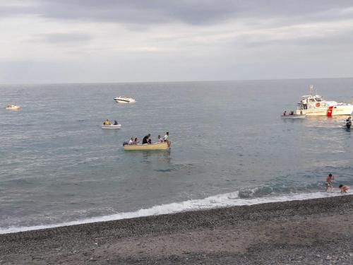 a group of people in boats in the ocean at Casa zoe in Marina di Monasterace