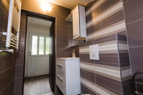 a small bathroom with a sink and a mirror at Apartmani Mabele in Pag