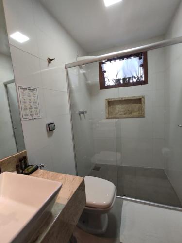a bathroom with a shower and a toilet and a sink at Terrazzo Suites in Capitólio