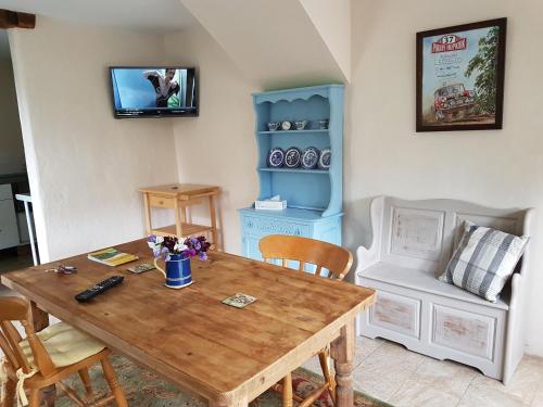 a dining room with a wooden table and chairs at Cottage - Sleeps 4 - Pets Ok - Garden - Parking in Carnforth