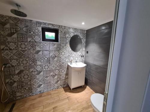 a bathroom with a sink and a toilet at Guest House Malusha in Gabrovo