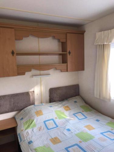 a bedroom with a bed with a colorful quilt on it at Rooms for Rent near Vilnius in Bezdonys