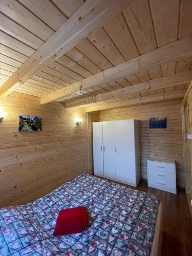 a bedroom with a bed in a wooden room at Domek letniskowy in Świnoujście