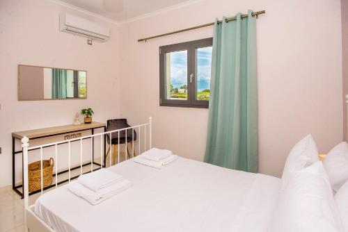 a bedroom with two beds and a window at Aella Apartment in Skala Kefalonias