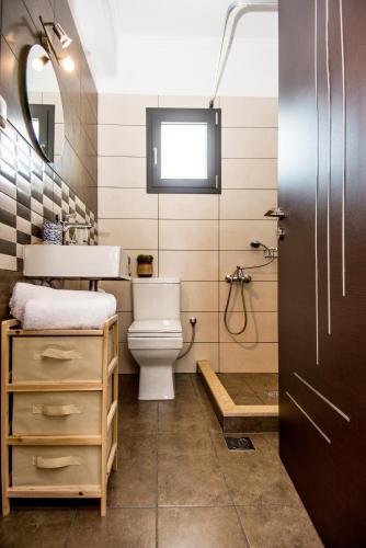 a bathroom with a toilet and a sink at Aella Apartment in Skala