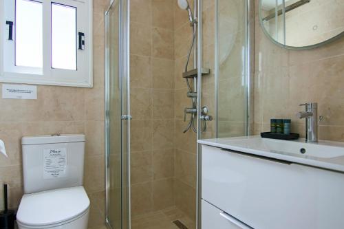a bathroom with a shower and a toilet and a sink at Phaedrus Living: Seaside Luxury Flat Lighthouse 62 in Paphos