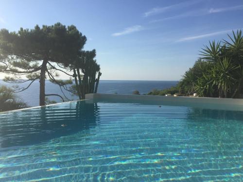 a swimming pool with a view of the ocean at Villa Mael in Ramatuelle