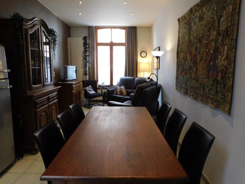 a dining room with a wooden table and chairs at Kruitenberg in Bruges