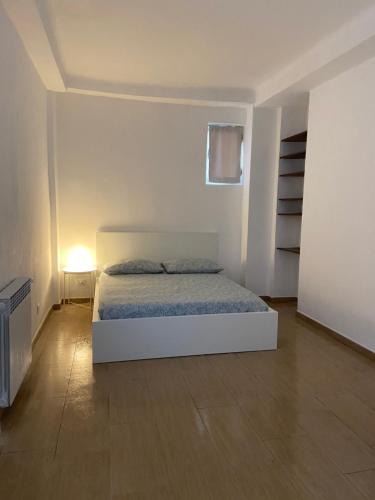a bedroom with a bed in a white room at Morosini 11 in Turin