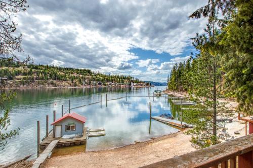 a lake with a small house in the water at CDA Lakefront Retreat in Harrison