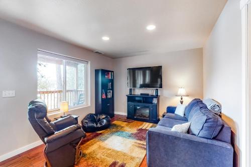 a living room with two couches and a tv at CDA Lakefront Retreat in Harrison