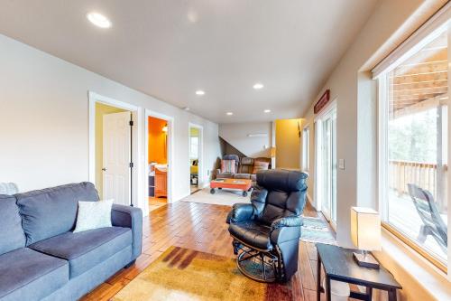 a living room with a blue couch and a chair at CDA Lakefront Retreat in Harrison
