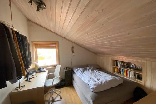 a room with a bed and a desk in a room at Marikollen, spacious appartment with sunny veranda in Kristiansand