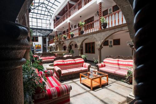 a lobby with couches and a table in a building at Munay Wasi Inn in Cusco