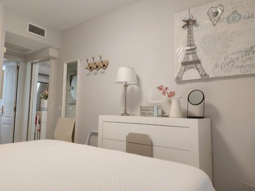 A bed or beds in a room at Love Rent4 Málaga Bajondillo Playa II